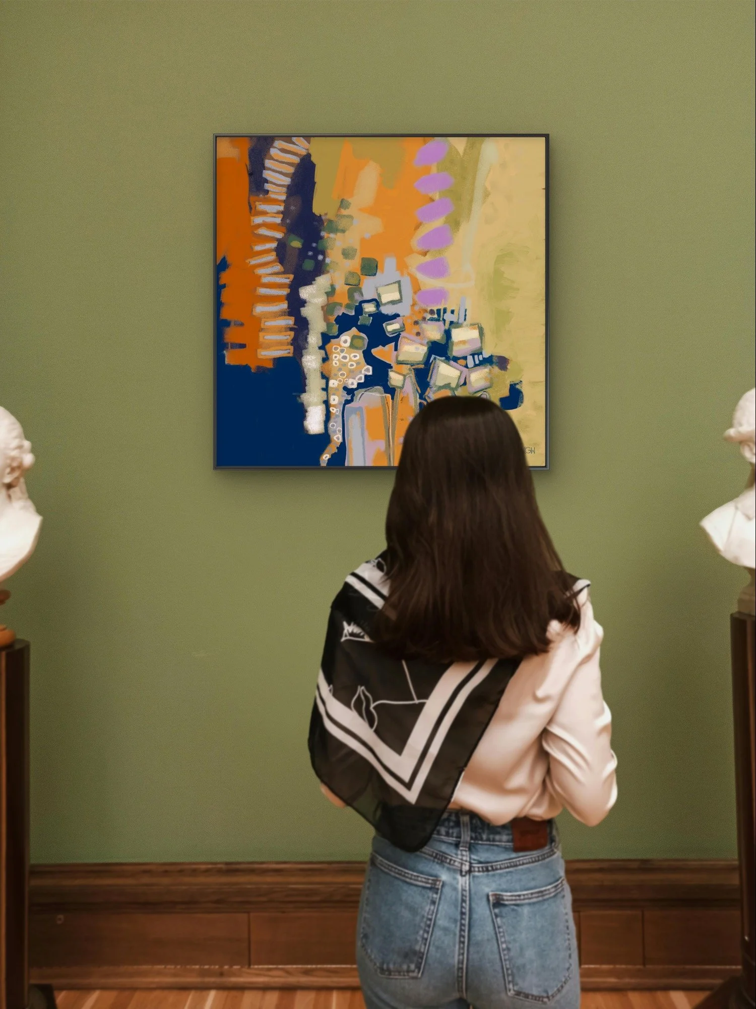 A woman with long brown hair, wearing a black and white jacket and blue jeans, is standing in an art gallery front of 'Hit a Nerve,' a contemporary abstract painting by Emily Whitish.