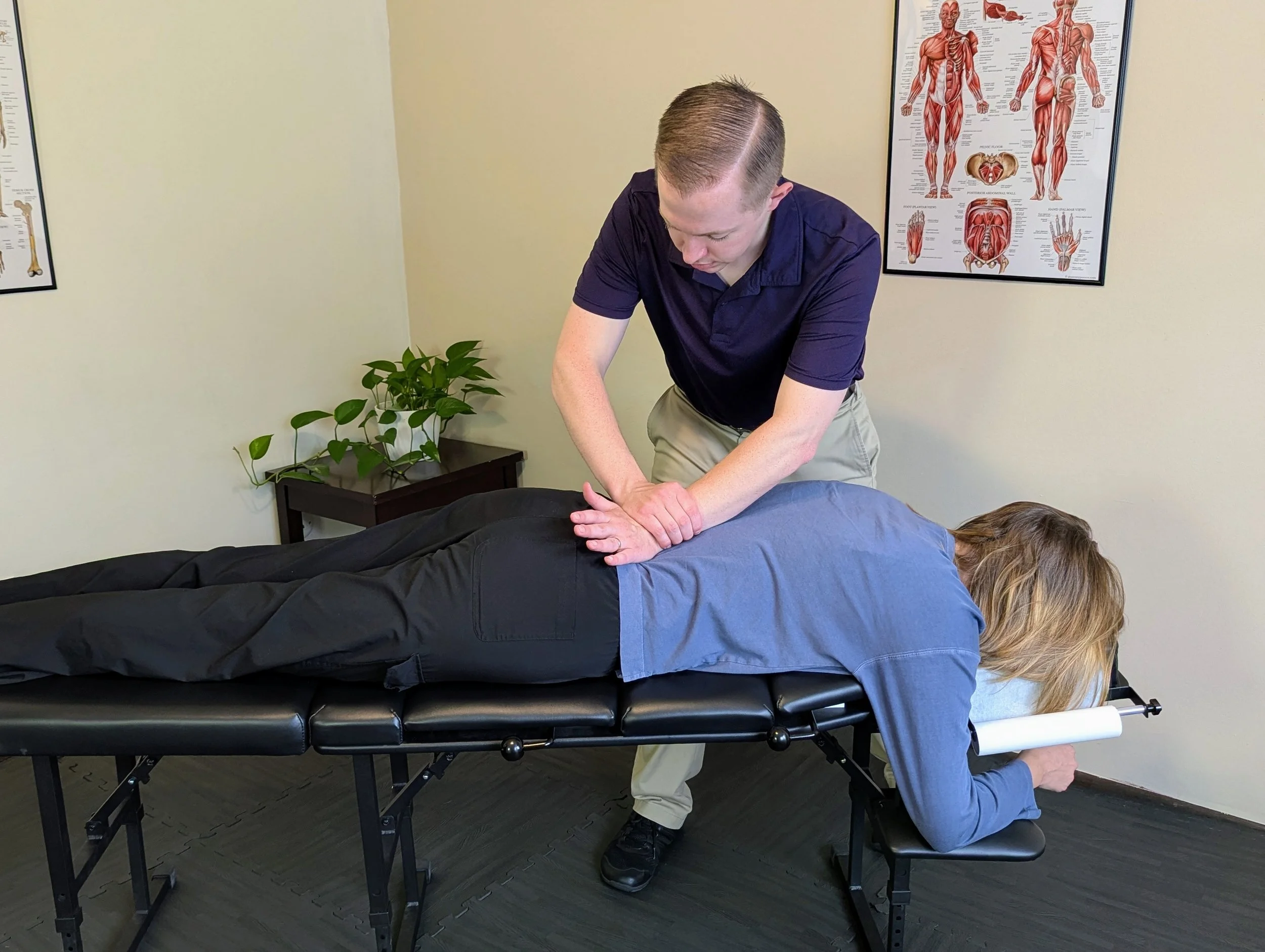 Mother receiving a pelvic chiropractic adjustment