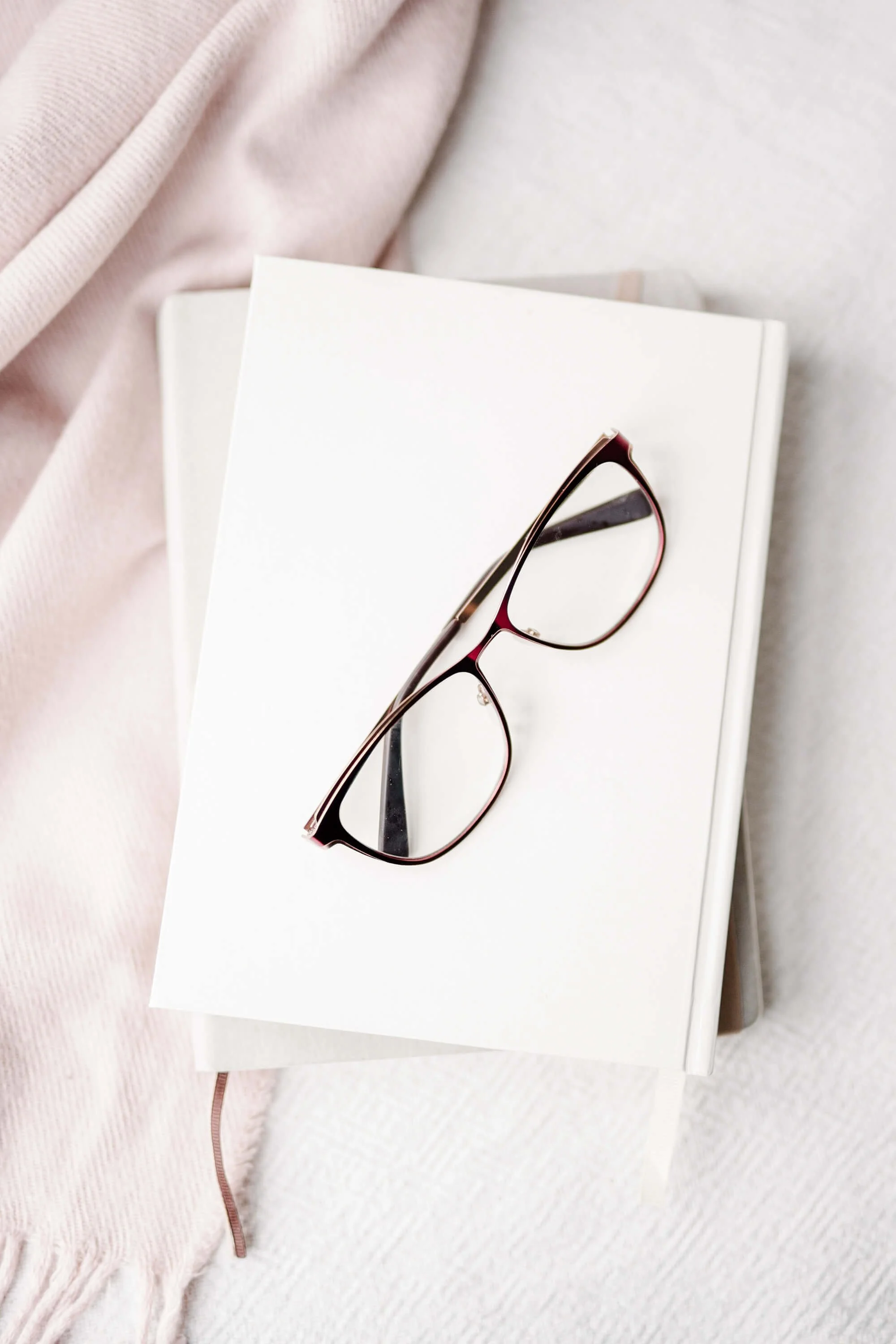 Notebook with eyeglasses representing reflection, clarity, and personal growth.