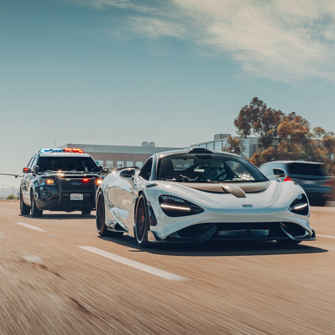 Police car chasing a McLaren photo shoot.