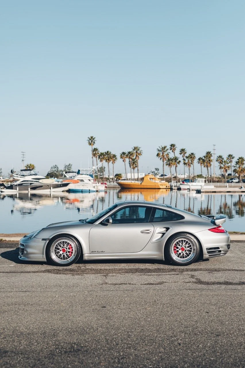 Porsche 911 in front of a Marina.