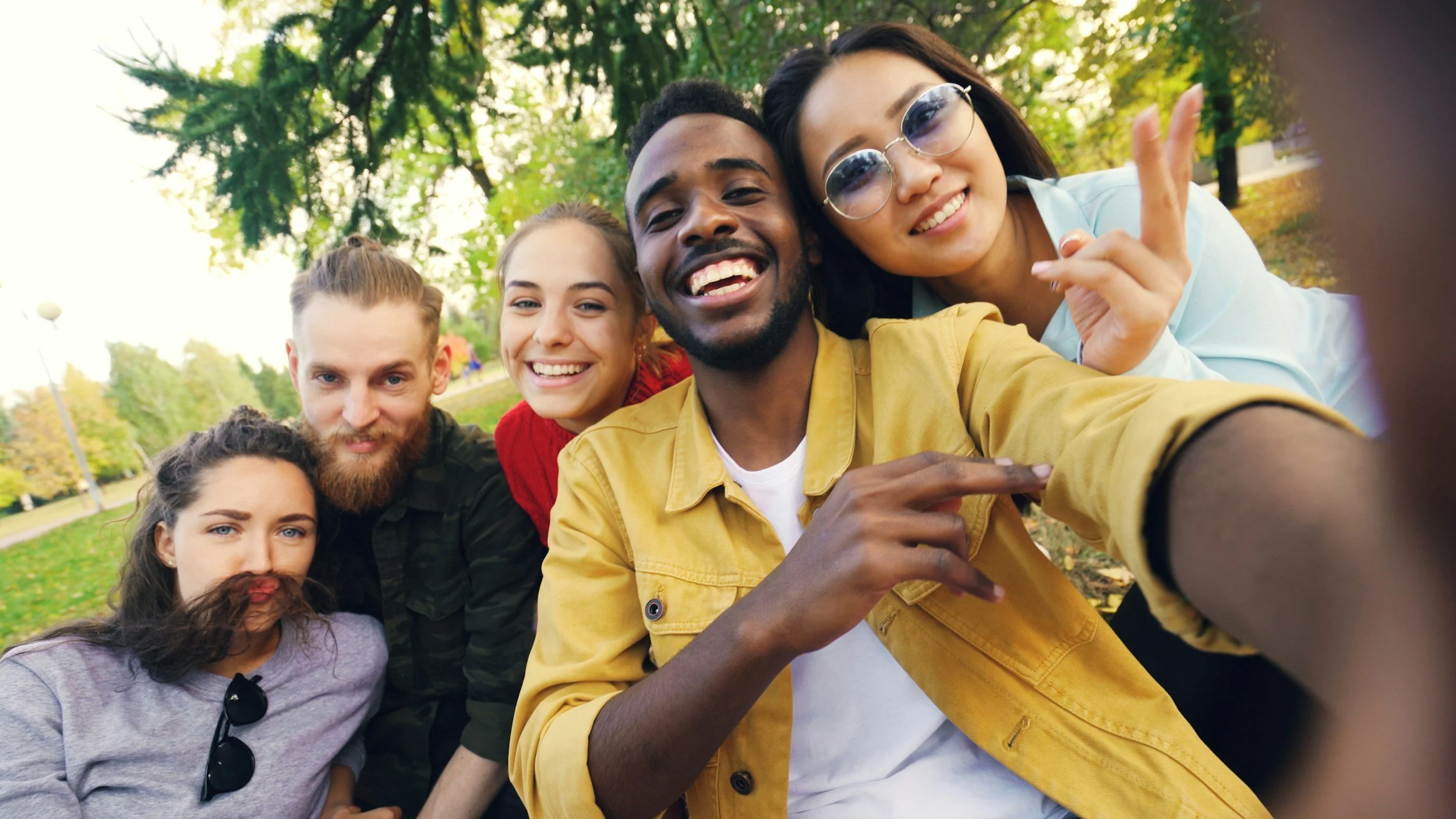 A diverse group of people taking a photo together, representing community, chosen family, and BIPOC therapy in Winter Park and Orlando, FL