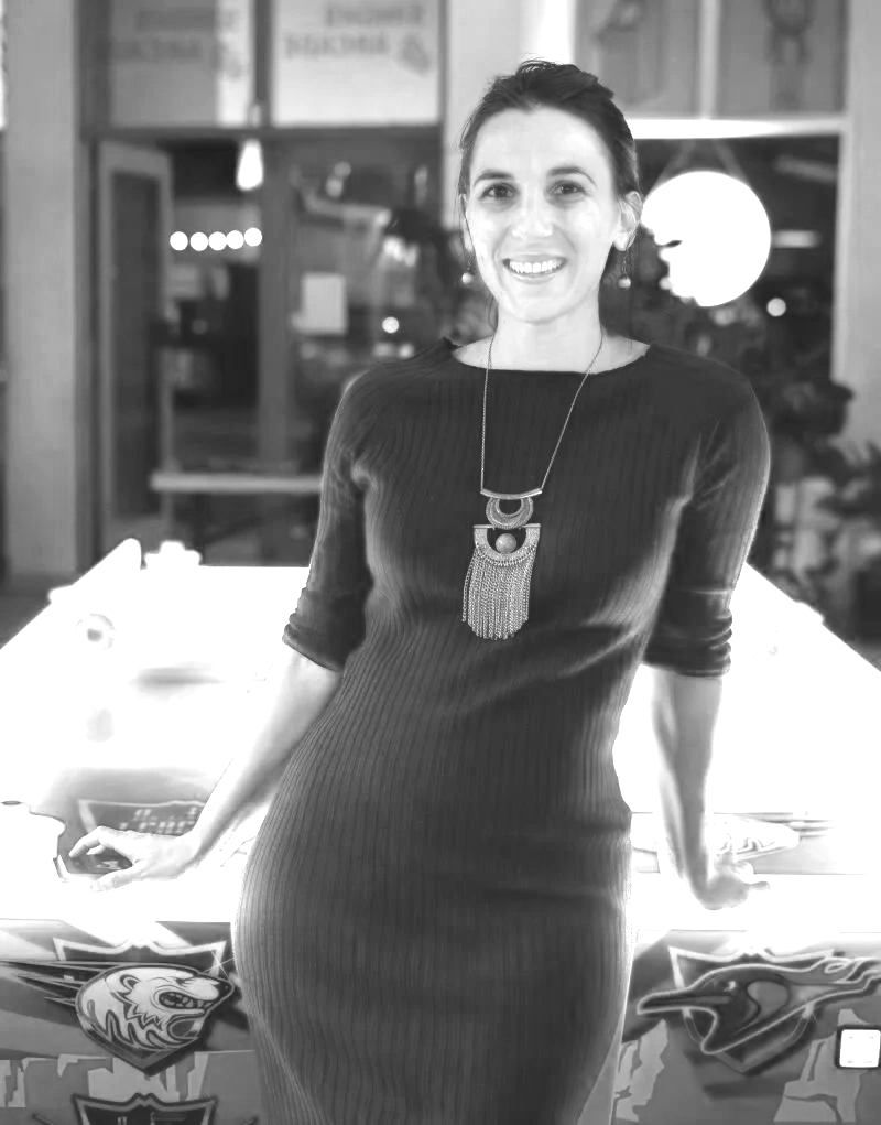Lorimanuelle at a Linkedin Local Event back in 2024. She looks straight up at the camera with a confident and genuine smile. She's wearing a long sleeves dress with a long amulet-alike necklace. The photo is in black and white.