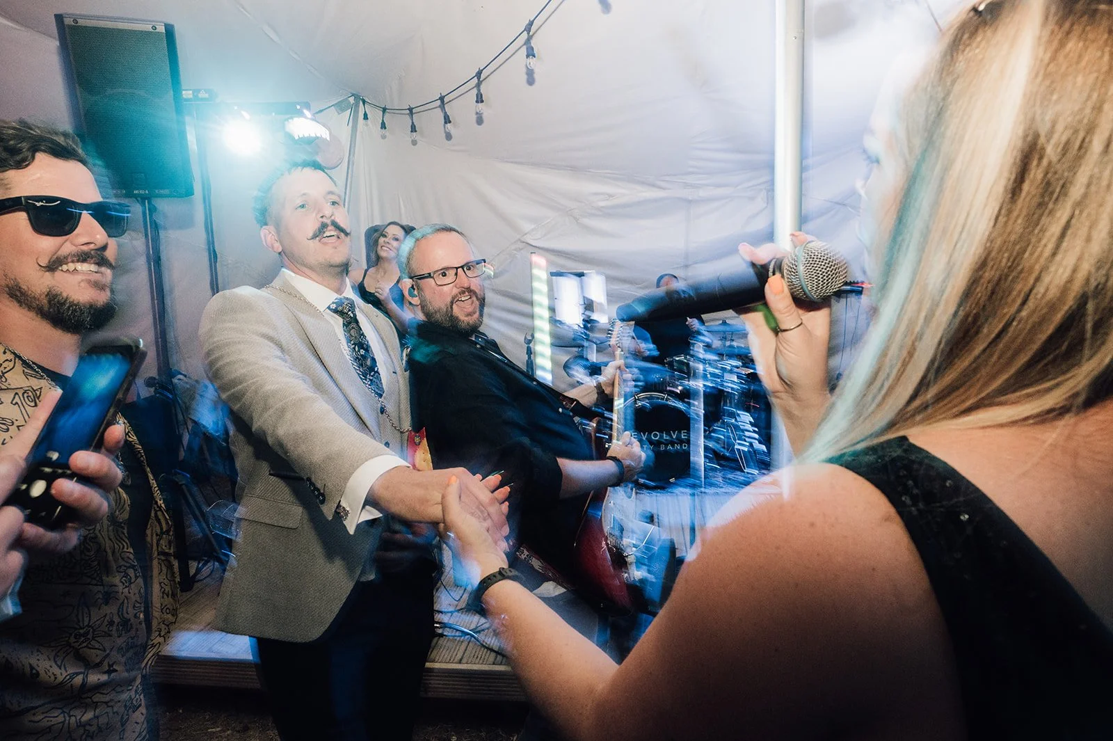 Revolve vocalist singing among guests at a Bedfordshire wedding celebration