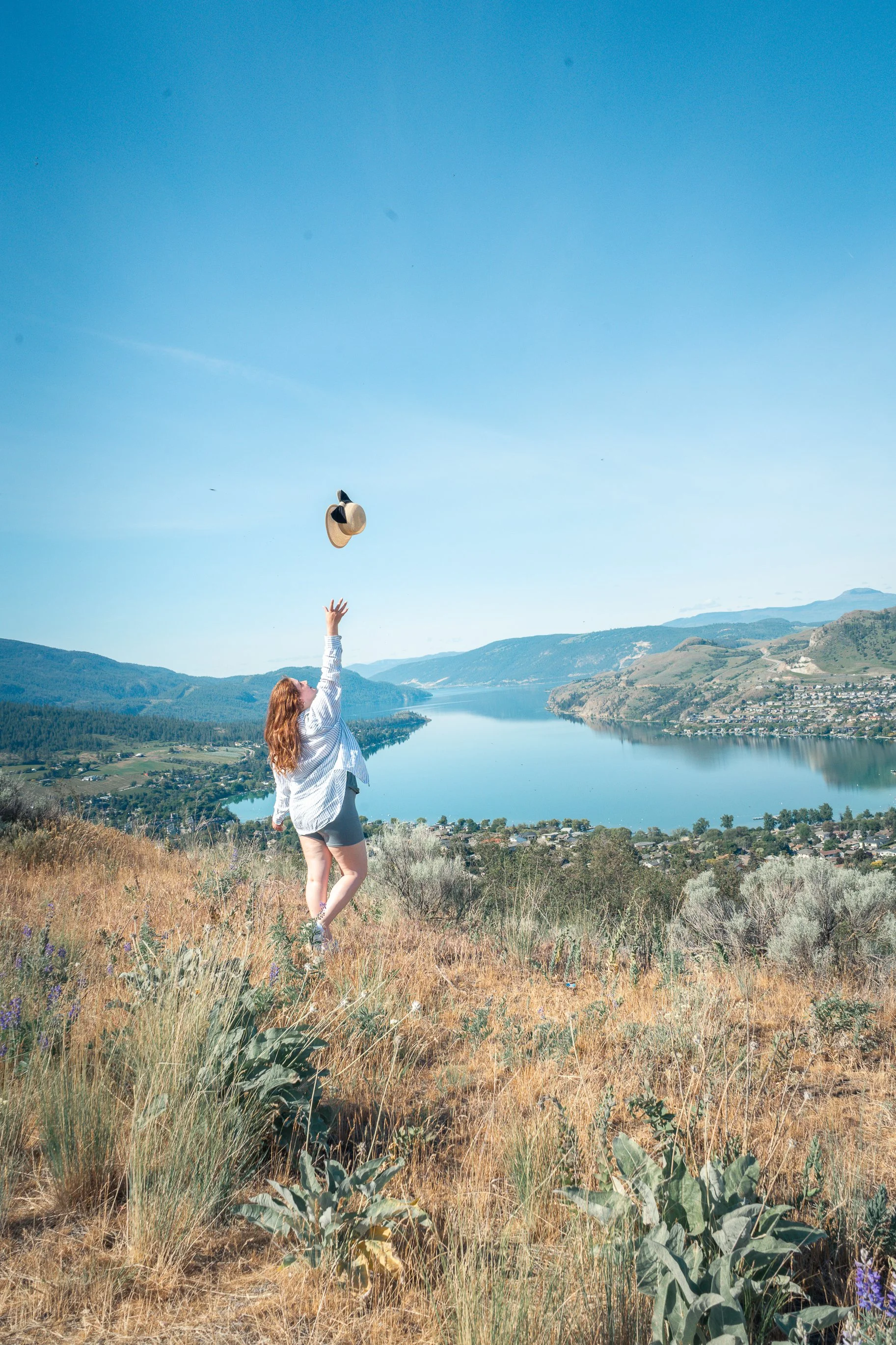 Celeste throwing sunhat in air in vernon