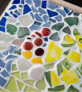 Close-up of colorful mosaic tile fragments in blue, red and yellow