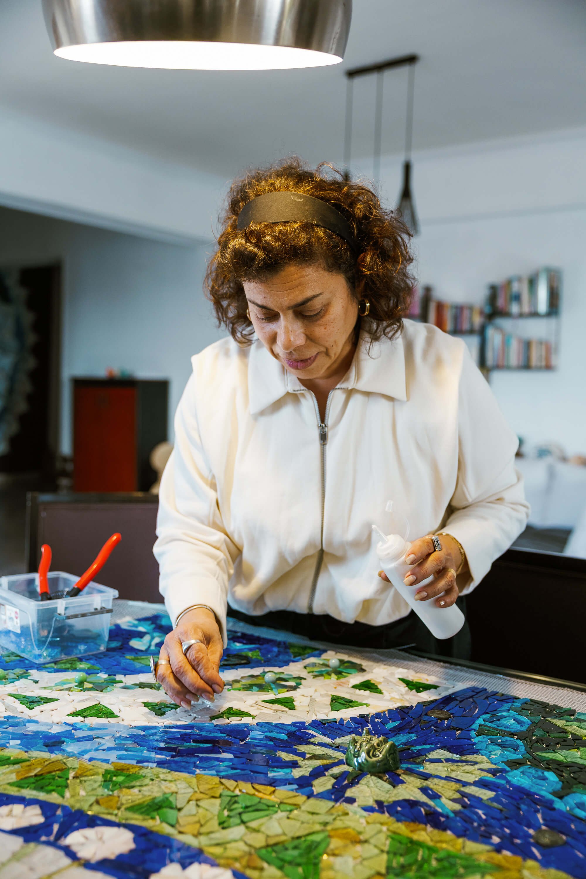 Azza at work, building a mosaic fragment by fragment