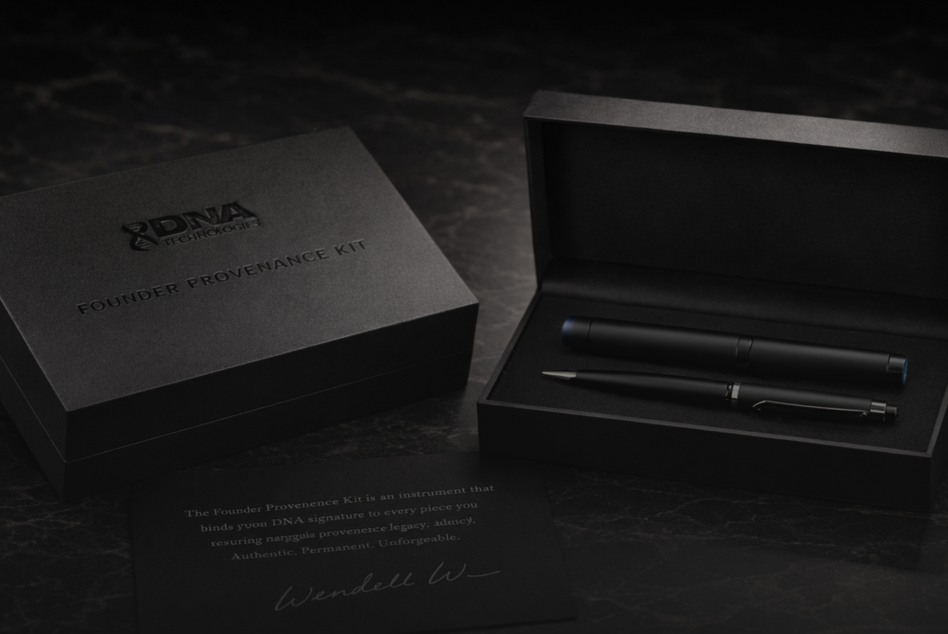 Black box labeled 'Founder Provenance Kit' with a pen and stylus inside, placed on a dark surface, with a note about the kit below.