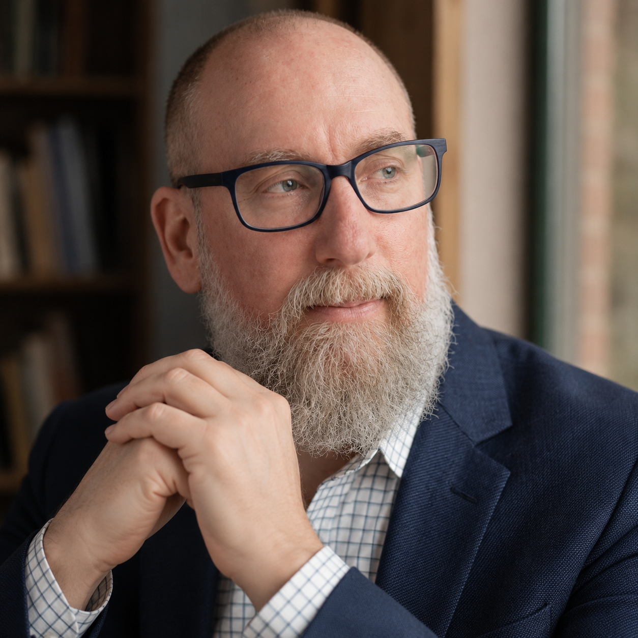 Brian Atkins, Author, looking thoughtfully out a window.