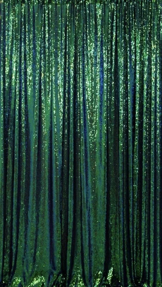 Green sequined curtain with vertical stripes reflecting light.
