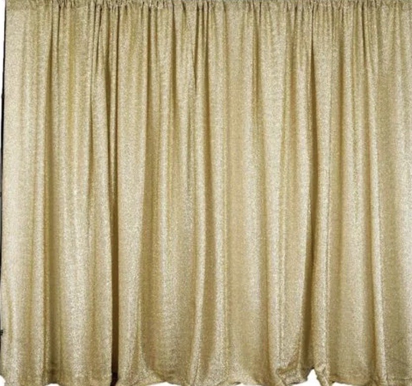 Golden curtains hanging in a stage setting.