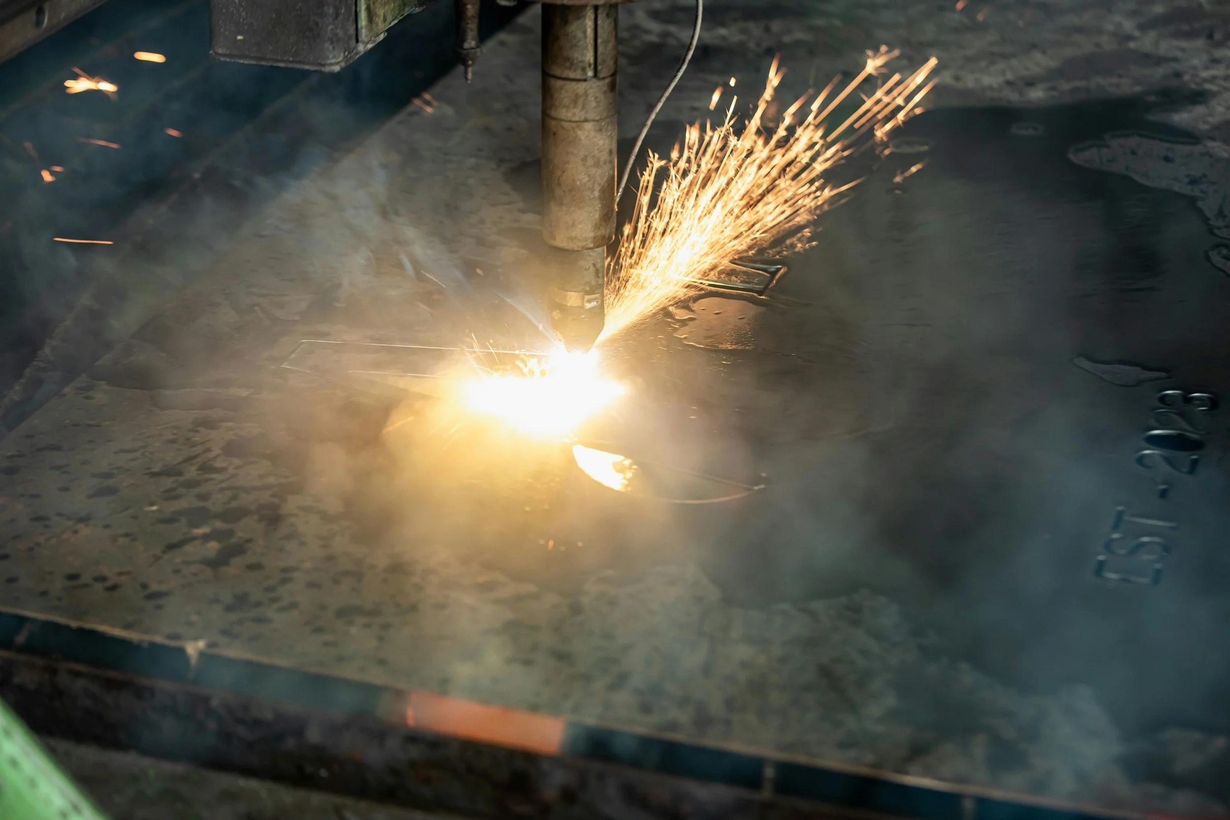 CNC plasma table cutting precision steel components.