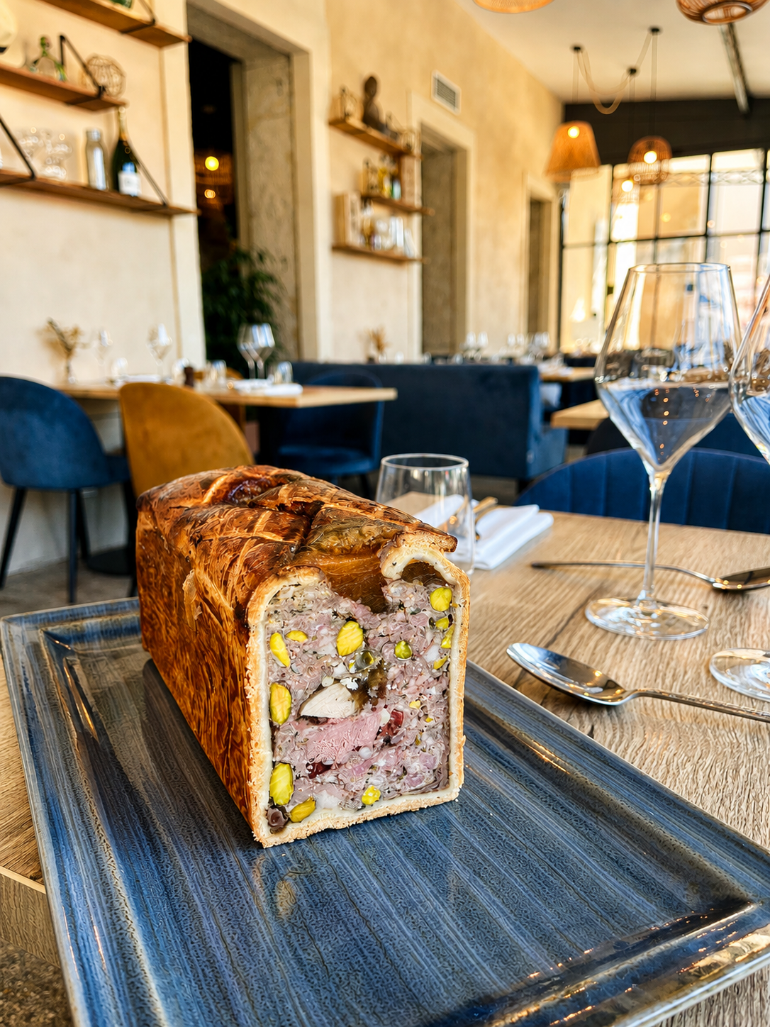 Un pâté en courte présenté sur une assiette à la brasserie de trévoux.