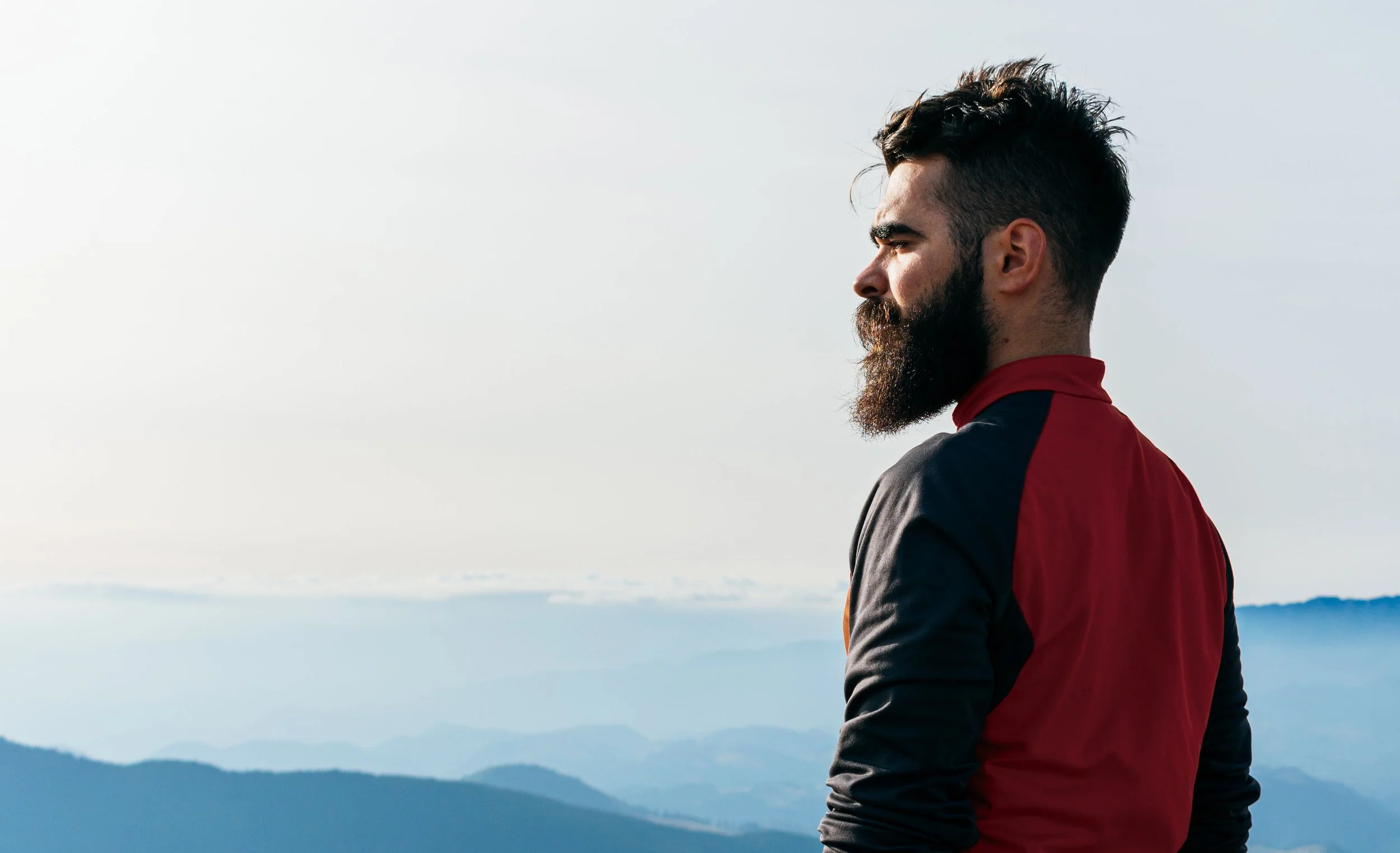 Biohacker and athlete looks across the mountain tops after a morning jog