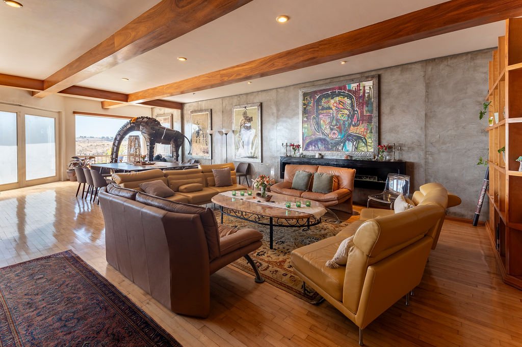 View across main room for group sharing and ceremony with painting and giraffe sculpture at The Mission Within retreat