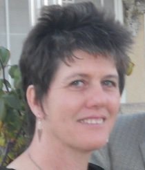 woman with short dark hair smiling in profile