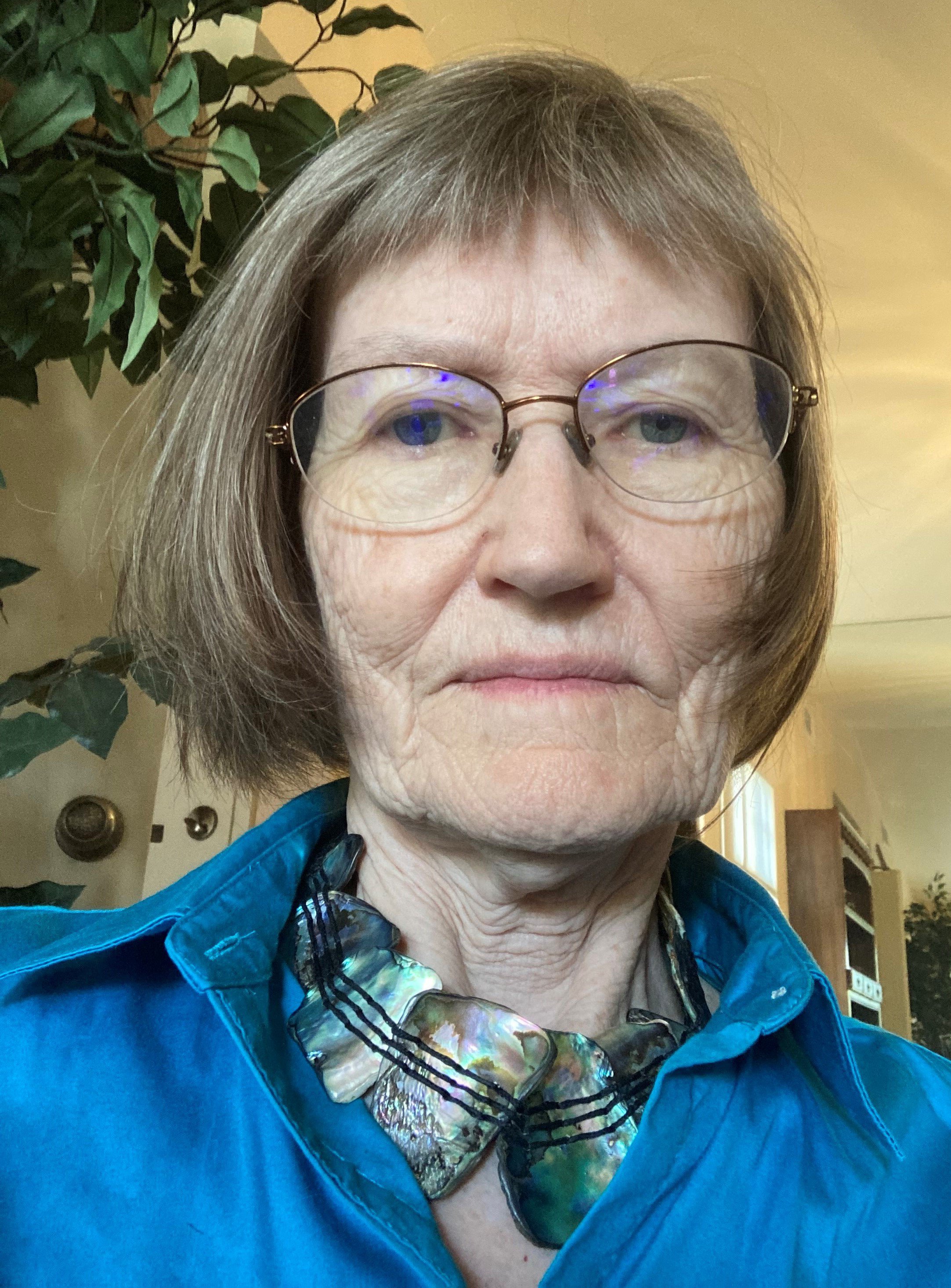 woman with glasses and short hair at home