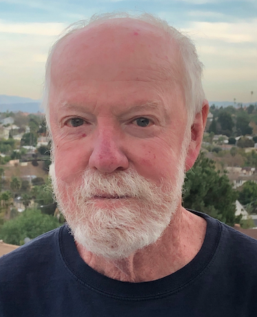 old man's face with landscape in the background