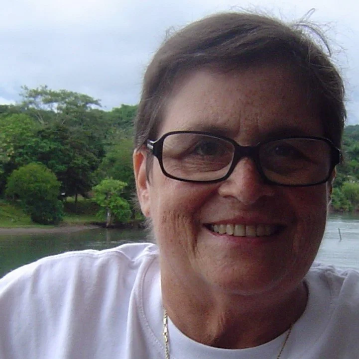 close up of a face wearing glasses in nature