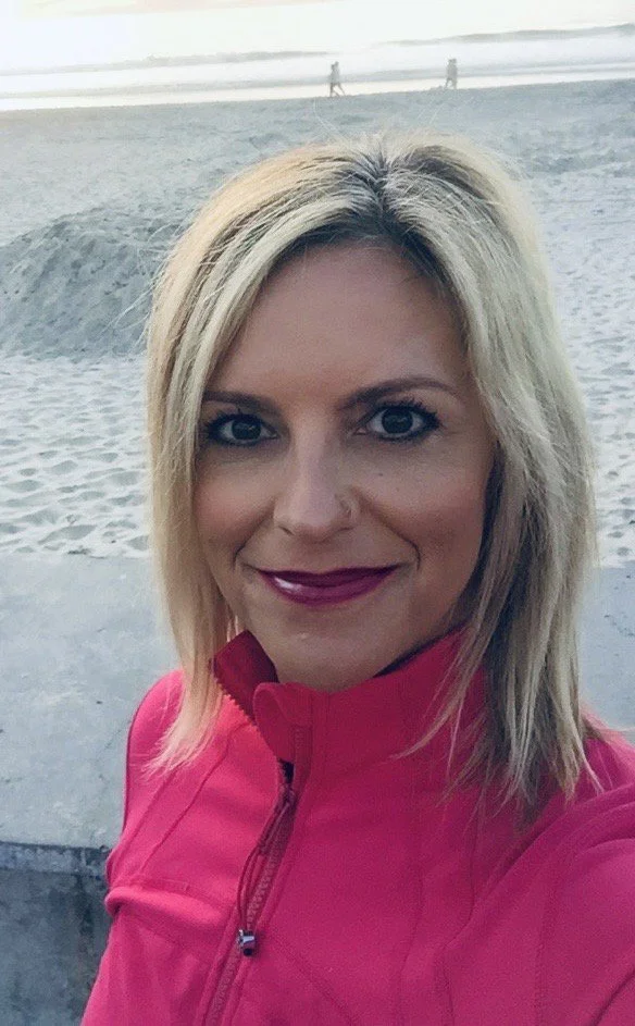 blonde hair women in pink at the beach