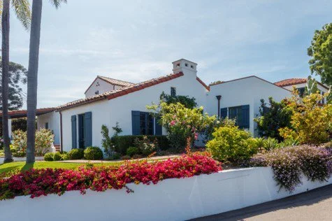 white house with shutters and a front garden