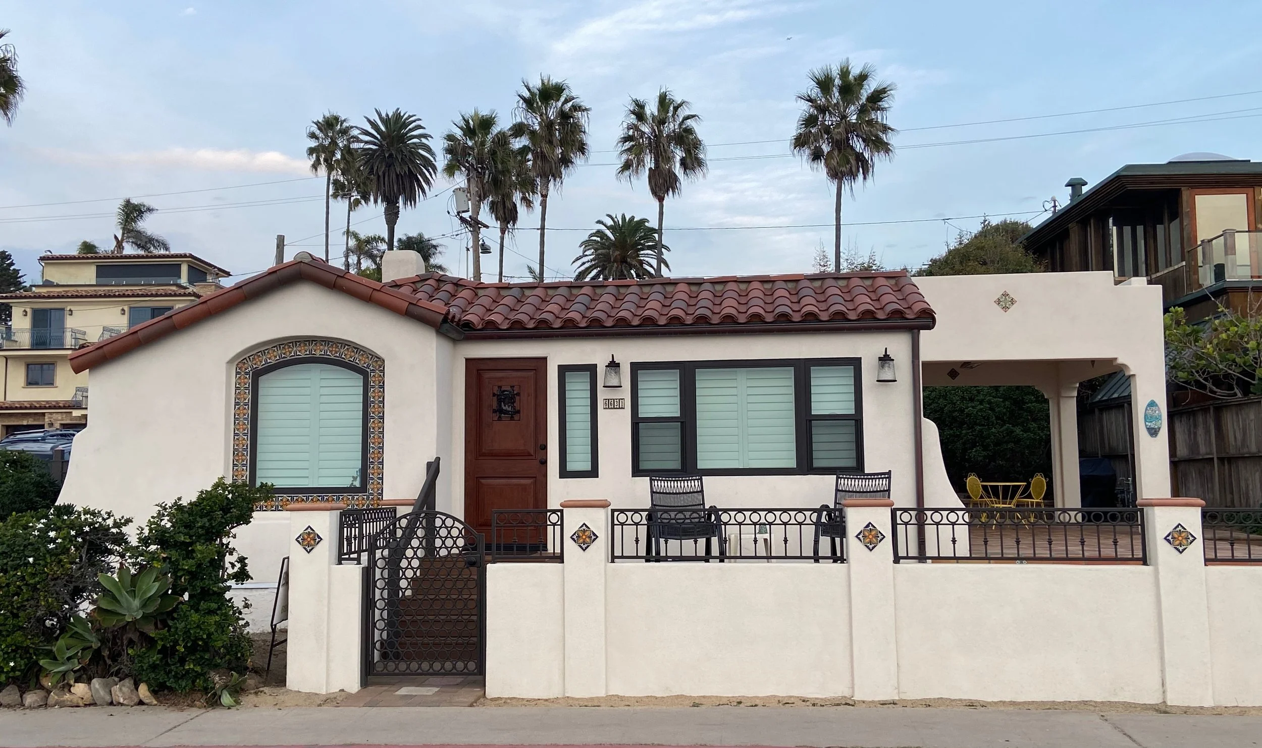 white Spanish style home with Palm trees