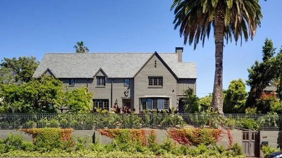 grey house with palm tree