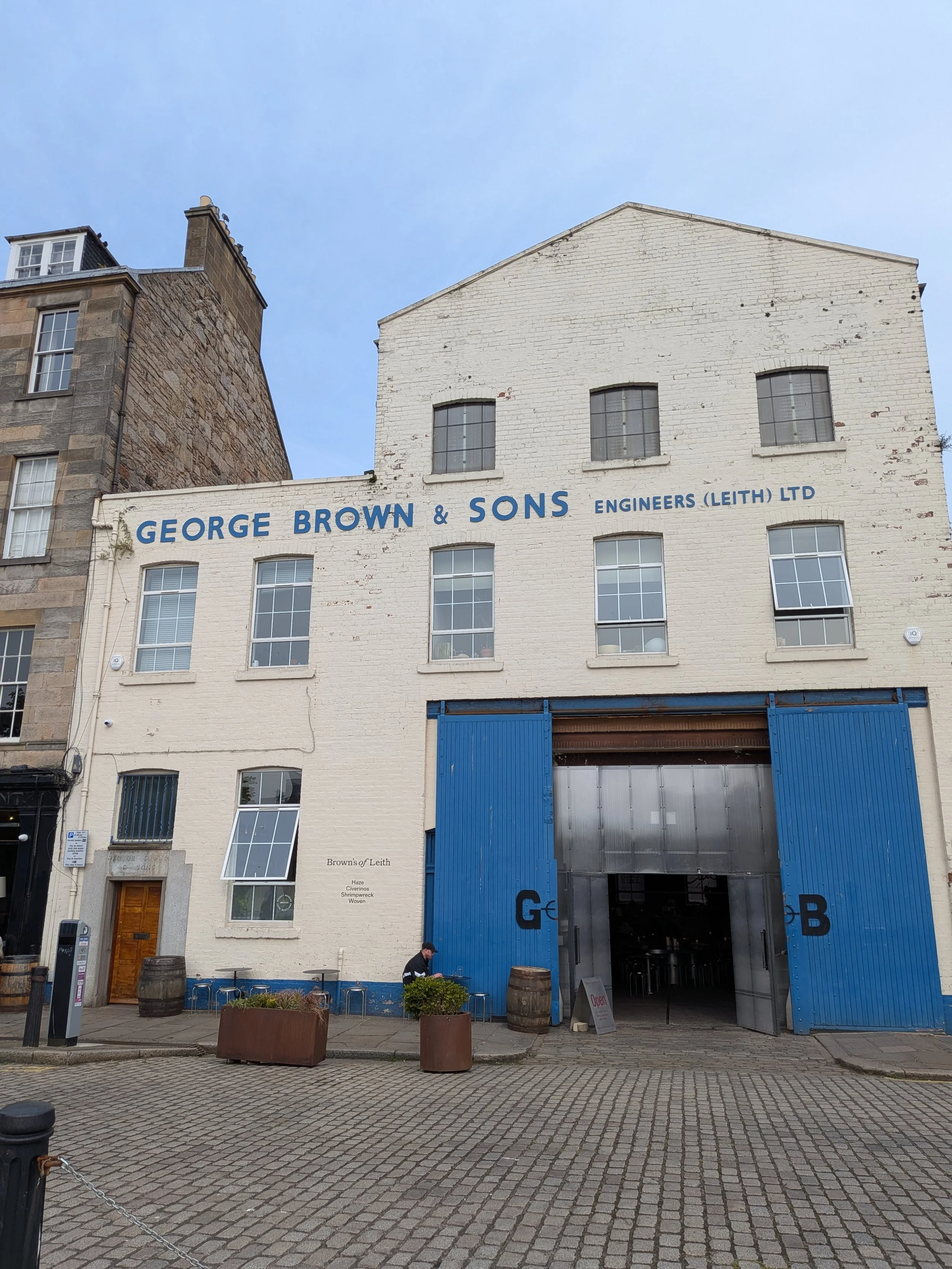 Large white brick building with blue letter and large blue stable doors