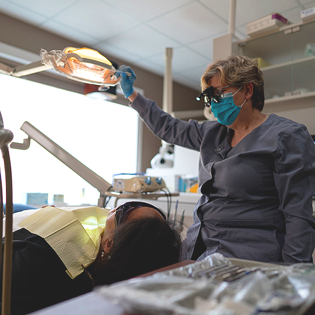 Patient receiving cosmetic dental treatment at Solutions Dental to improve her smile with personalized cosmetic dentistry care.