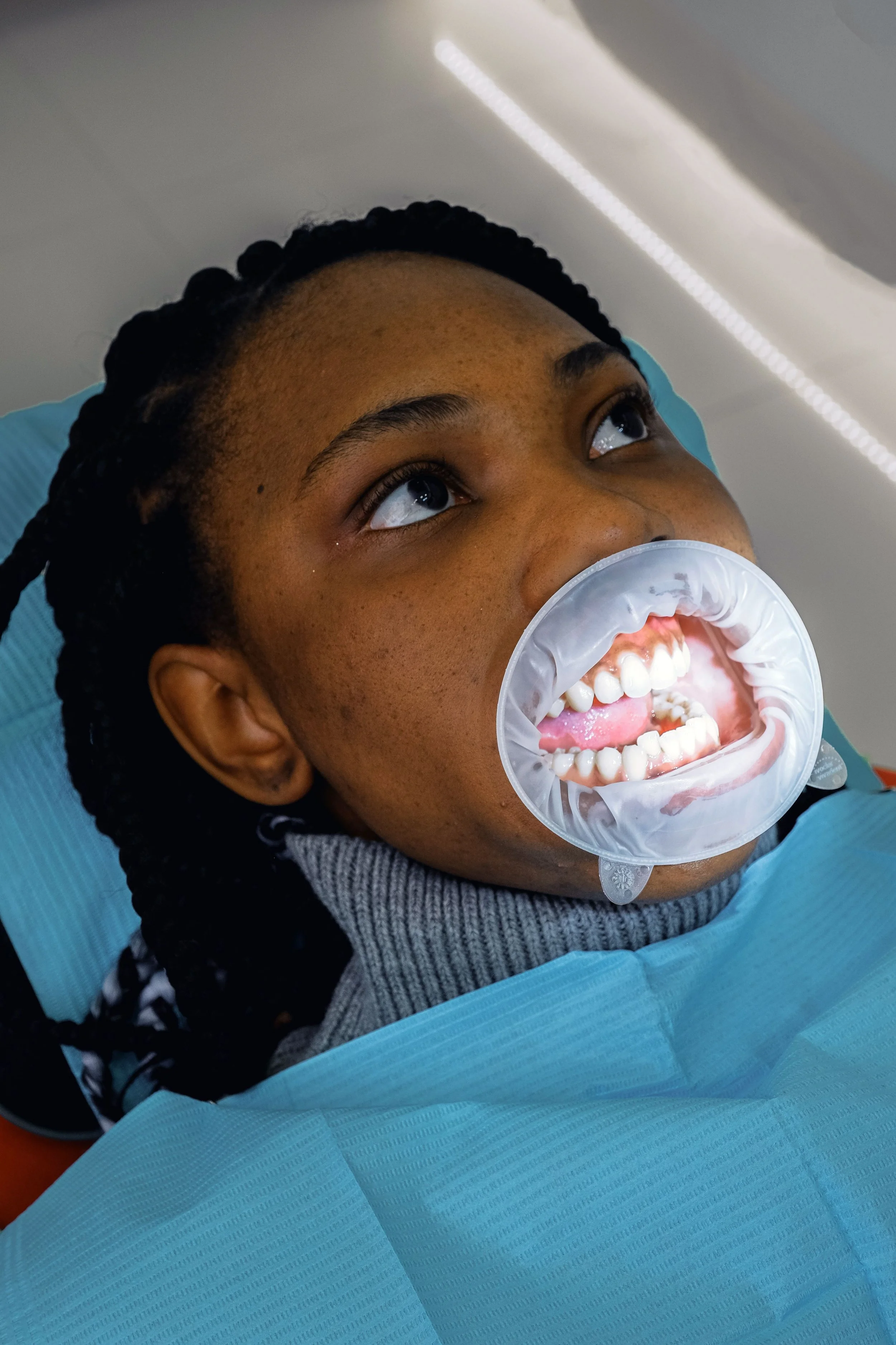 Patient receiving cosmetic dental treatment at Solutions Dental to improve her smile with personalized cosmetic dentistry care.