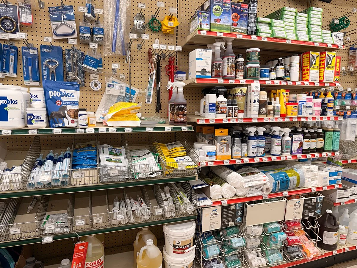 A store shelf stocked with pet supplies, including medications, grooming products, and veterinary items.