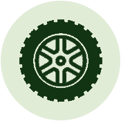 A gear-shaped object with a circular center and intricate internal patterns, set against a light green background.