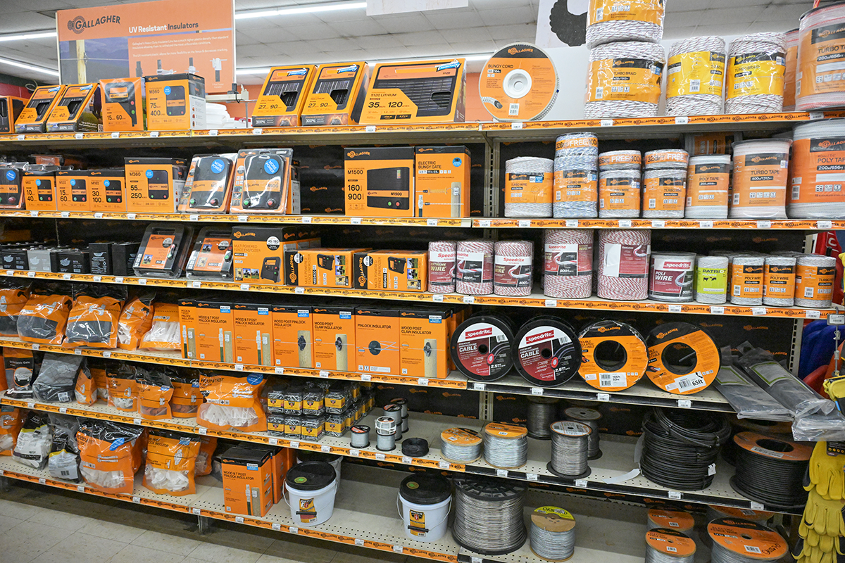 Store shelf stocked with insulation materials, wires, and electrical accessories, with packaging mainly in orange and black.