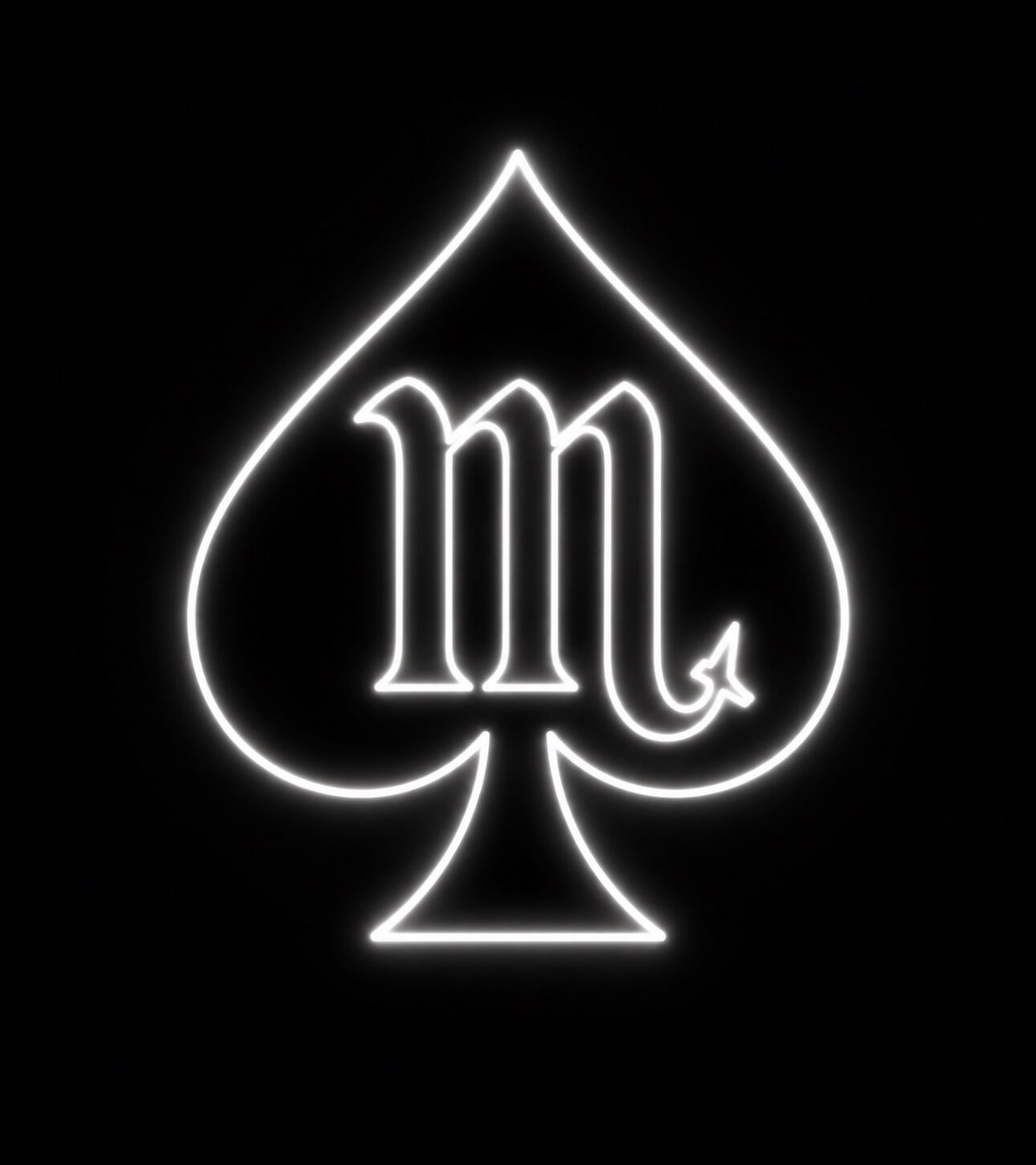 Neon sign in the shape of a spade playing card symbol with a stylized letter 'M' inside.