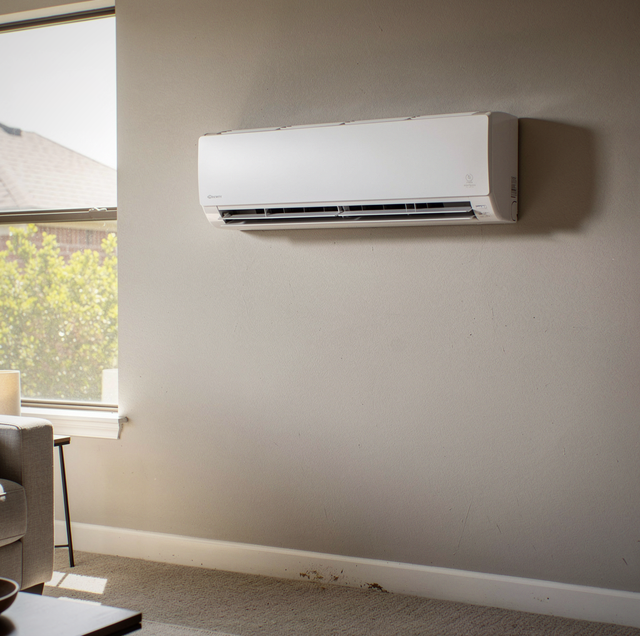 White ductless mini split mounted high on bedroom wall
