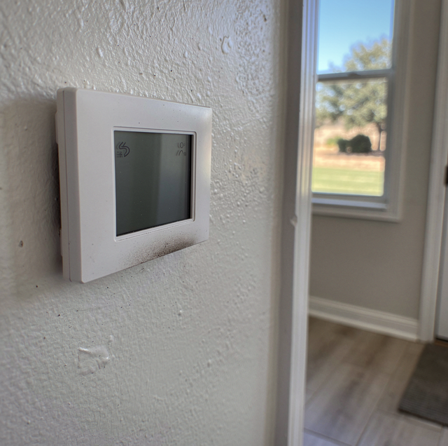 air conditioner unit blowing warm air indoors