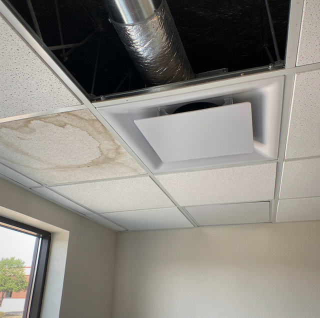 weathered commercial rooftop hvac unit on gravel roof