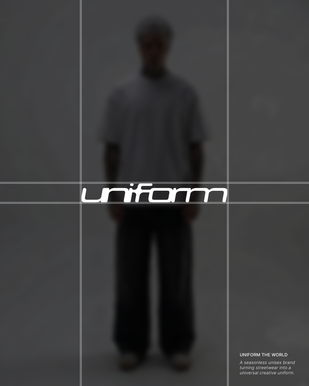 Un homme portant un T-shirt gris, détendu, avec le texte "Unif orm" en avant, modèle de streetwear unisexe, face à un fond gris