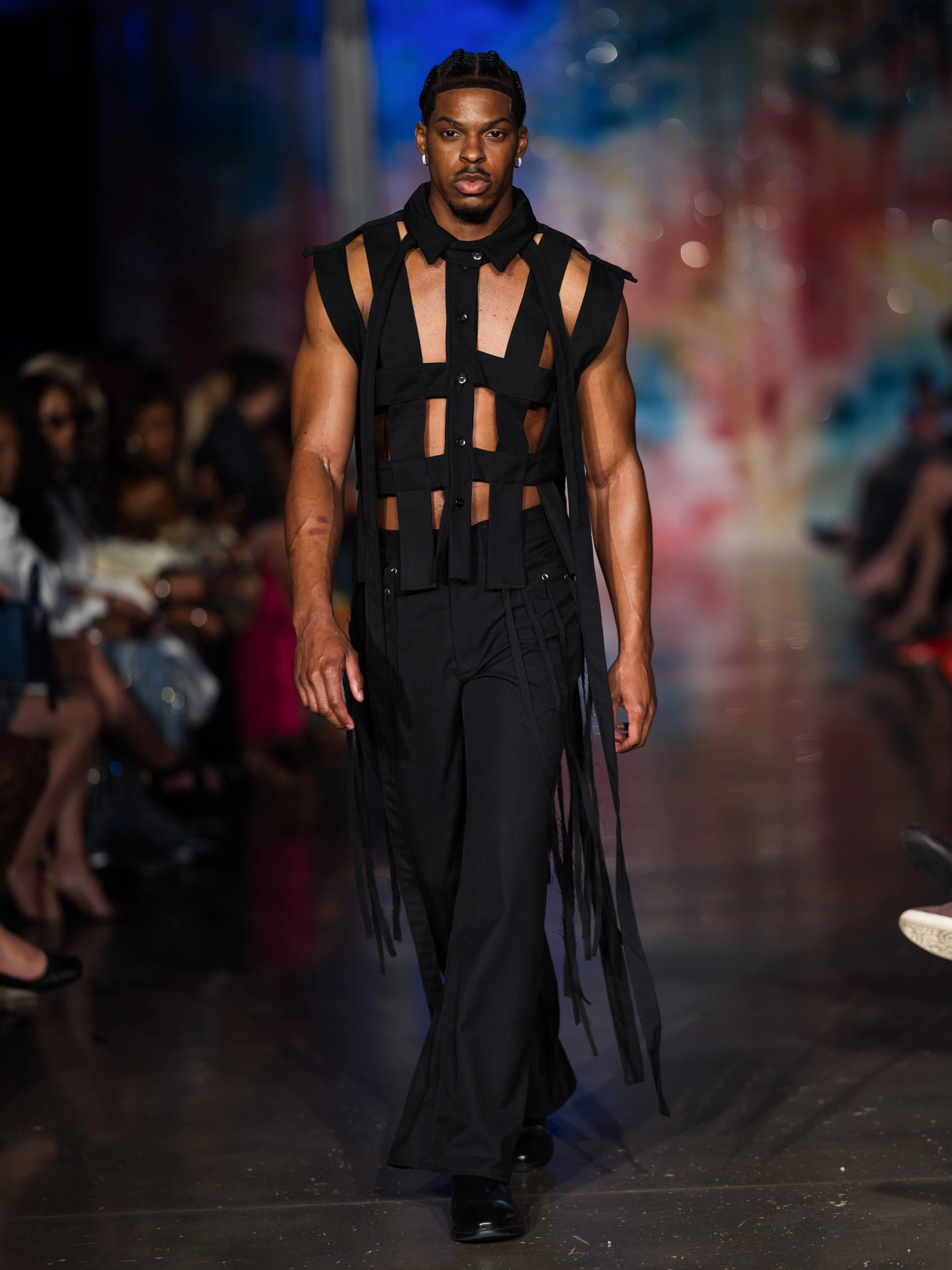 Look twelve 

The finale. The inescapable reality we&rsquo;ve created for ourselves. This look shows this black vest that was created in inspiration of a jail cell. We are trapping ourselves into this made up society of greed and fear. By adding the 