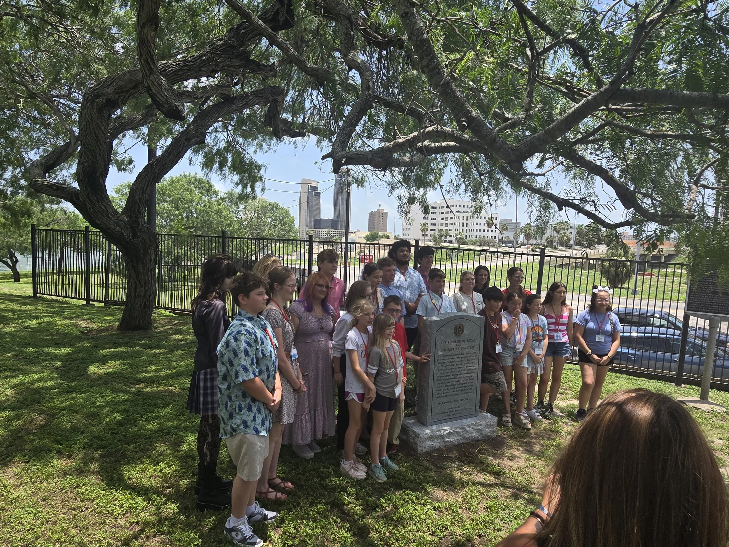 CRT at Bayview Cemetery A large group of children gathered around a historical marker