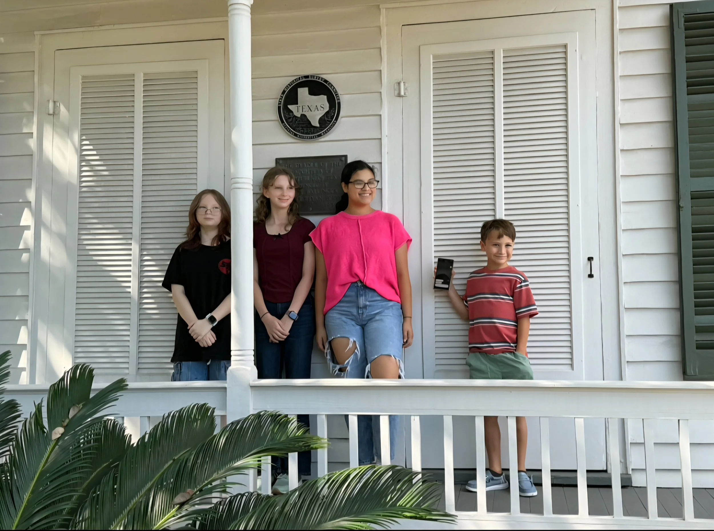 CRT at the Cradle. Four children standing on the front porch