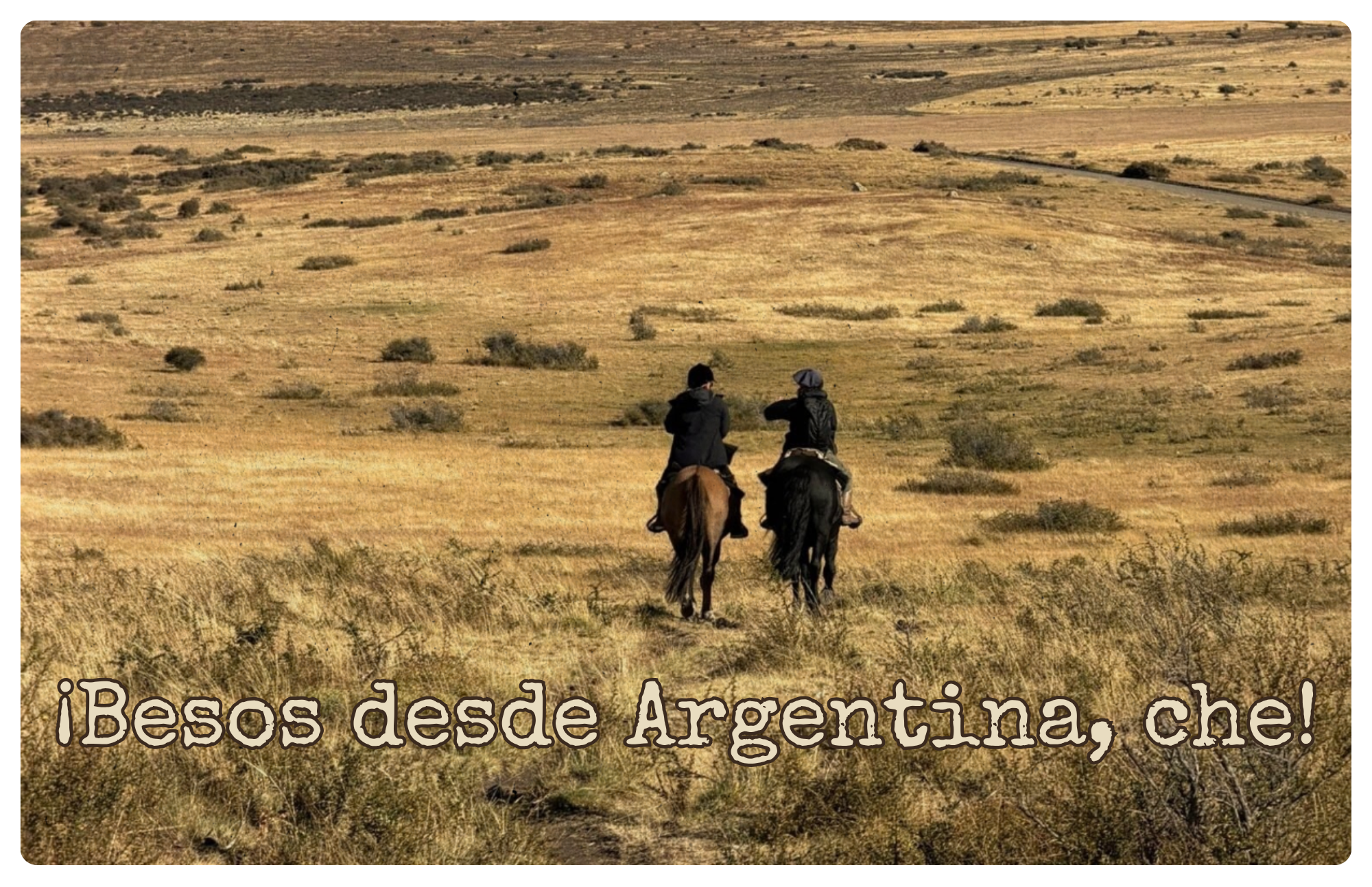 Two riders on horseback crossing golden Patagonian steppe toward distant hills, with the greeting ¡Besos desde Argentina, che!