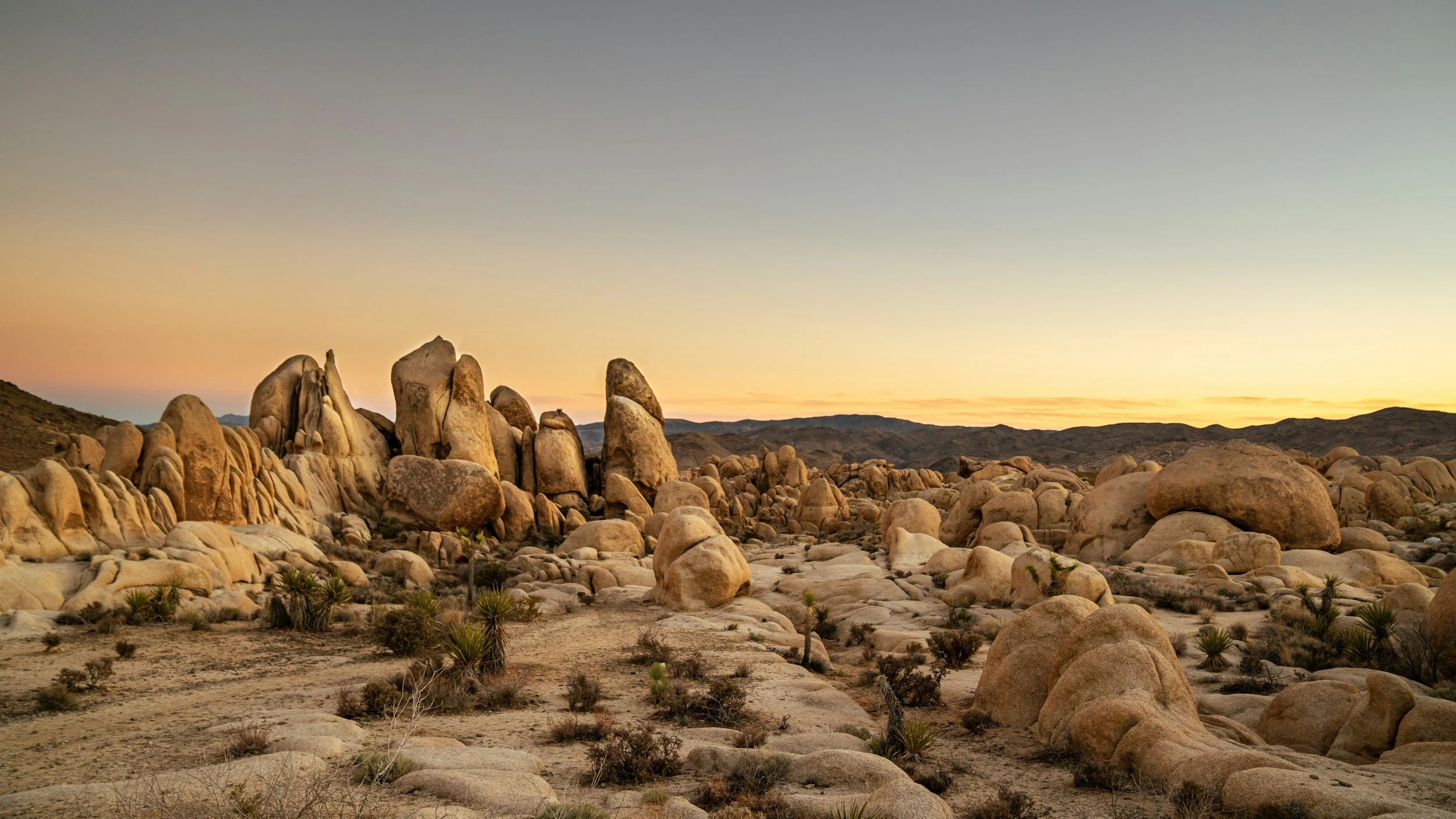 Granite boulders glowing at sunset in Joshua Tree National Park, California.