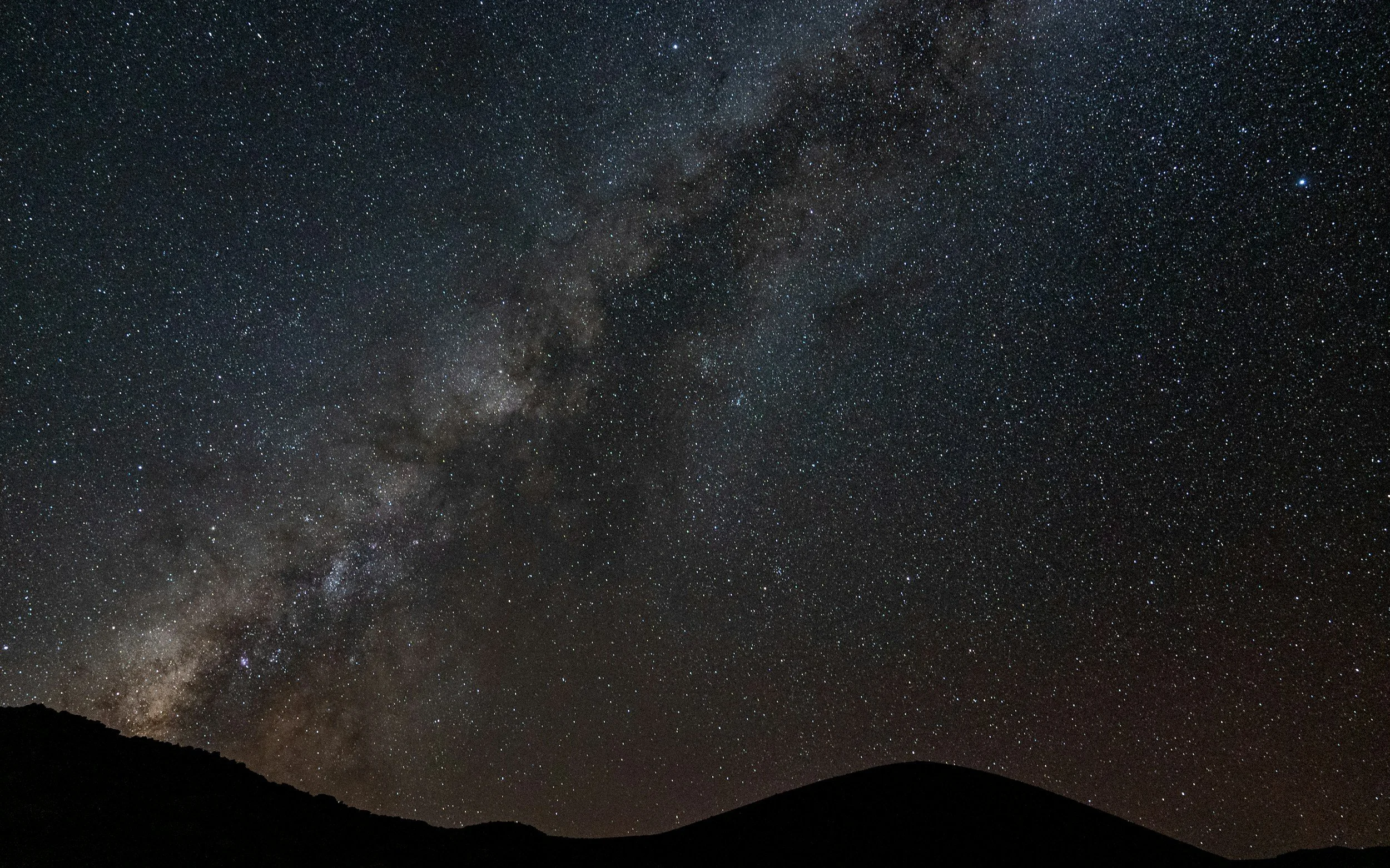 Milky Way stretching above the mountain peaks of Hawai'i