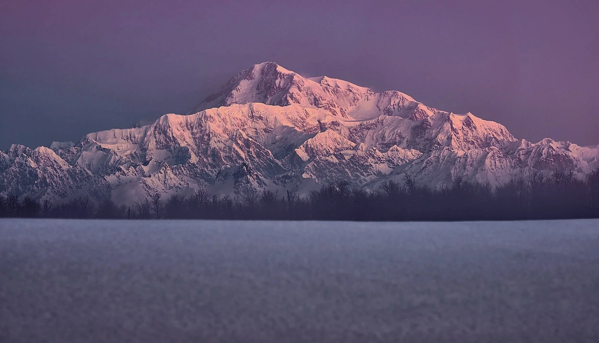 Denali glowing pink at sunset above the Alaska Range in Denali National Park, Alaska