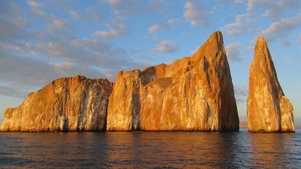 Kicker Rock, two sheer volcanic rock towers split by a narrow channel, rising from the deep blue sea off San Cristóbal.