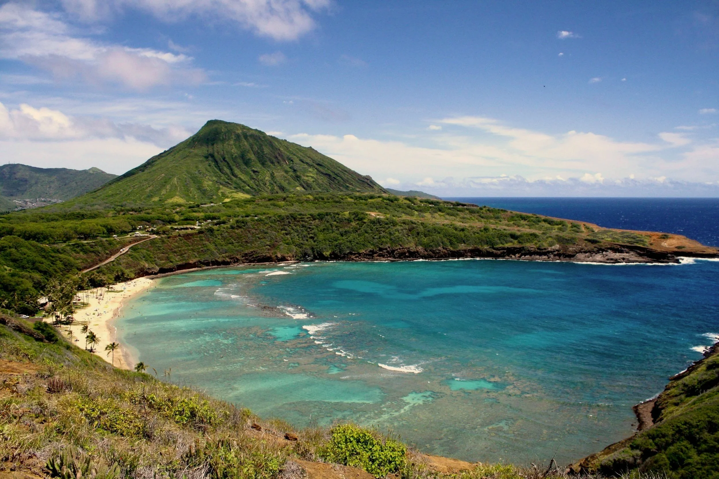 i need image text for oahu,  Hanauma Bay's turquoise water and green crater rim on the southeast coast of Oahu, Hawai'i