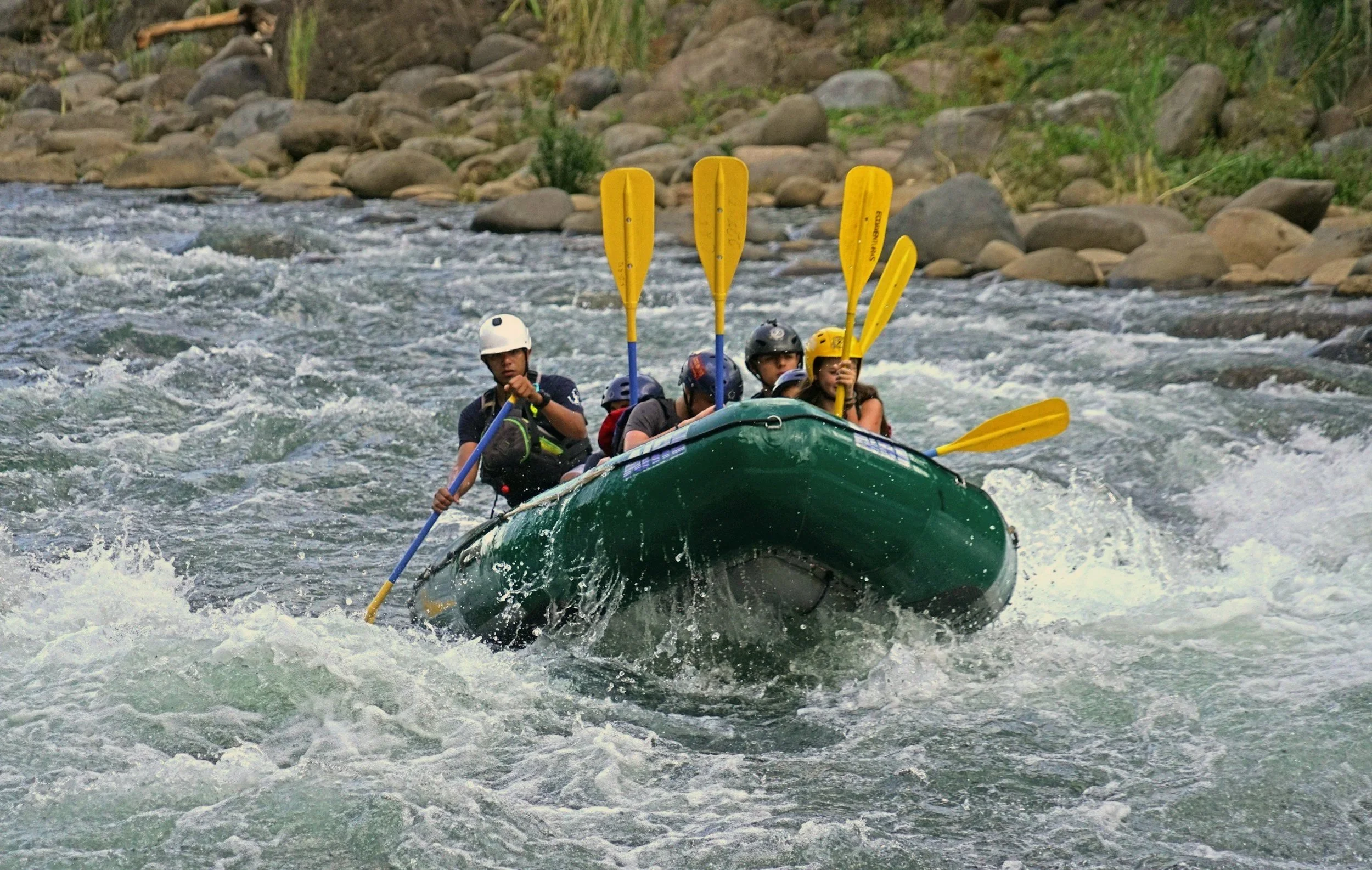 Raft moving through whitewater in a rainforest gorge on the Pacuare River, Costa Rica