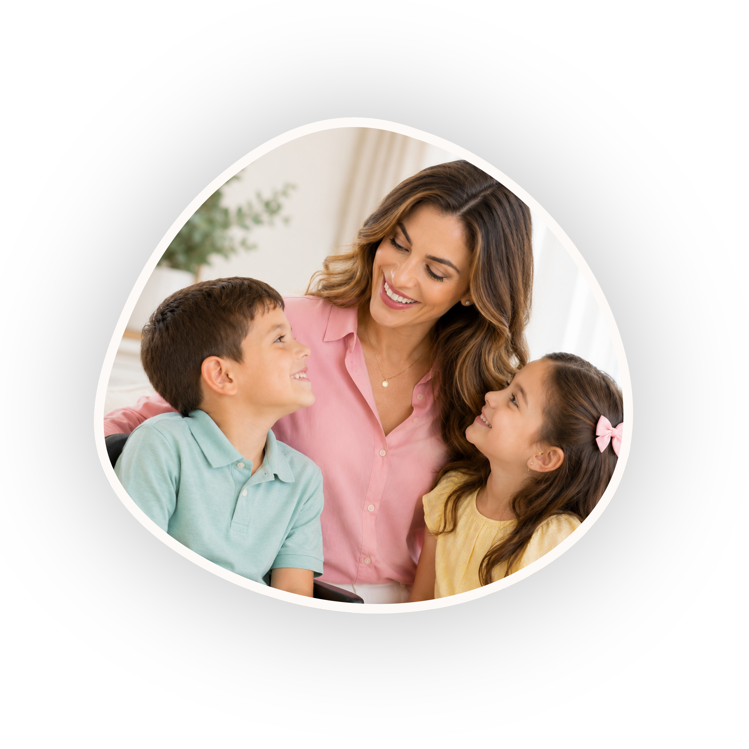 A smiling woman with long brown hair interacting with two children, a boy and a girl, in a warmly lit room.