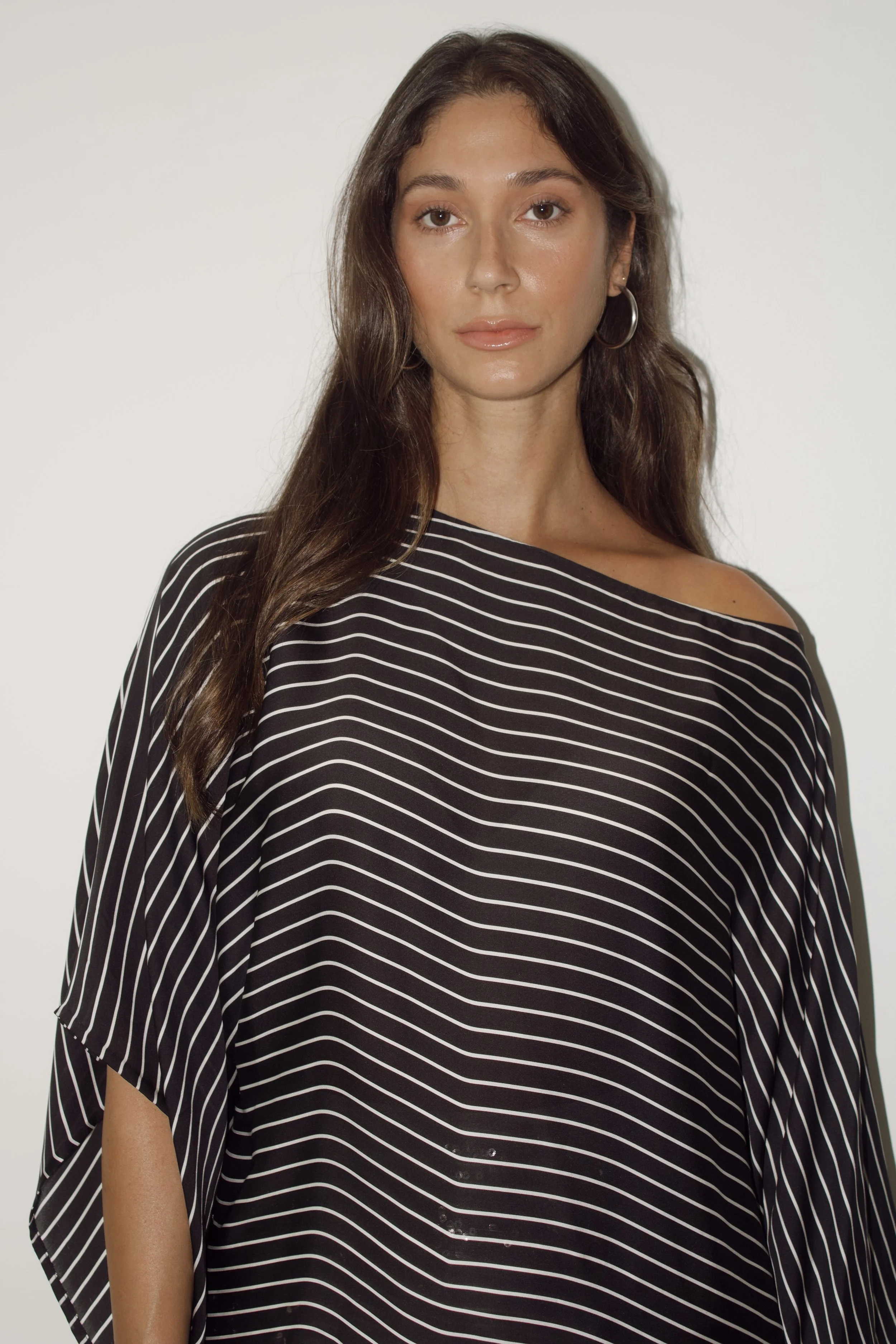 a model stands in a studio wearing a black and white striped ralph lauren top